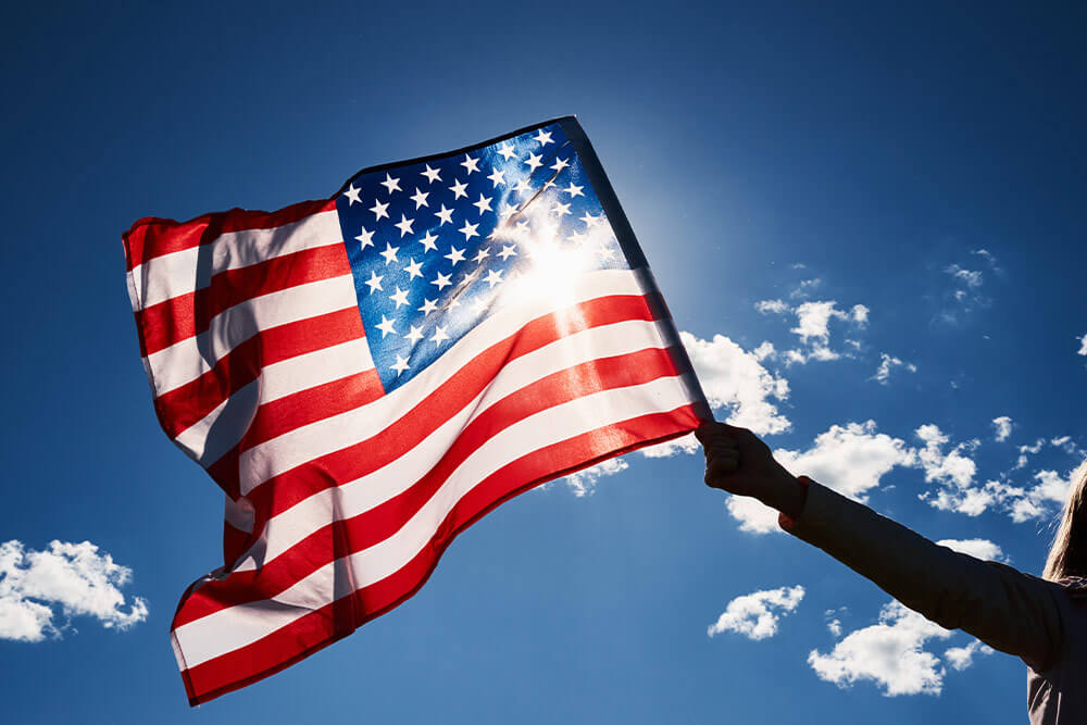 American flag with sky in background.